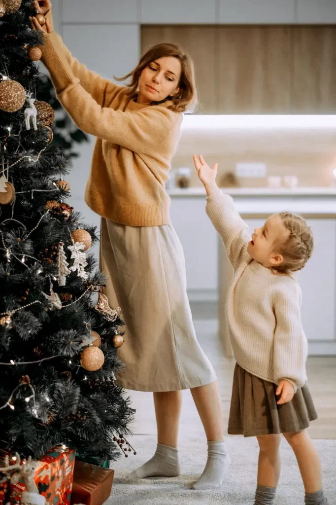 Mother and daughter decorating a Christmas tree