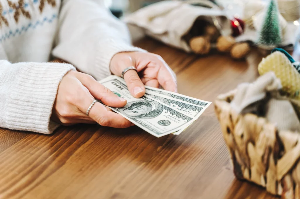 Picture of a woman's hands holding cash.